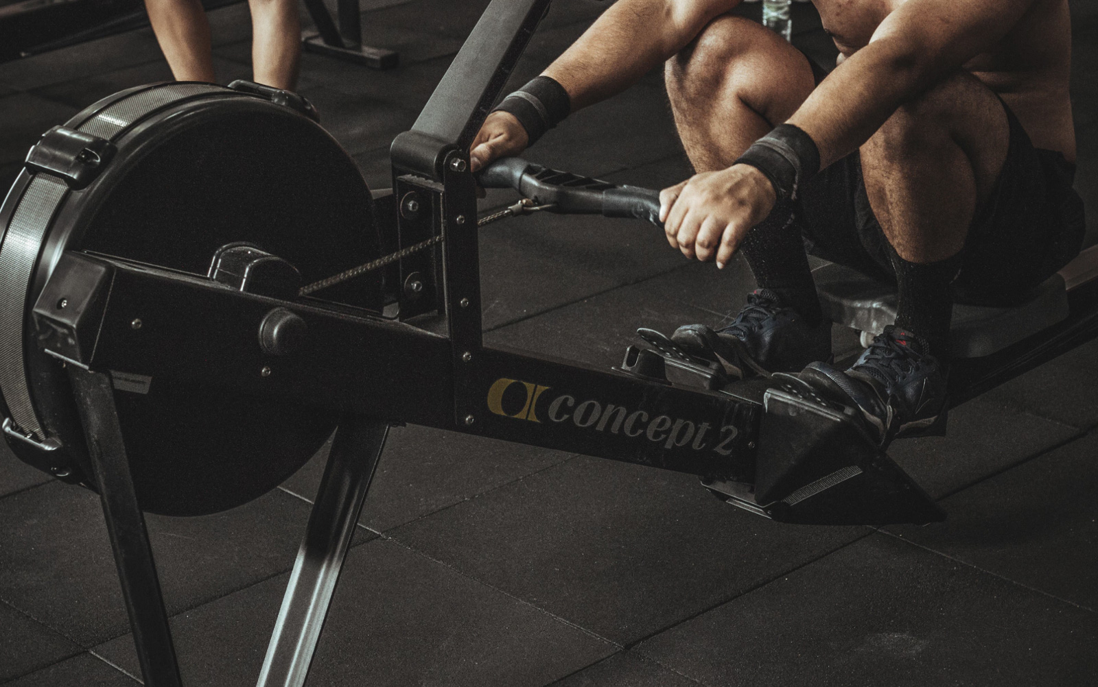 A man rowing on the rowing machine.